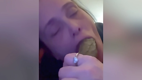 A mature brunette is giving a big cock in her mouth